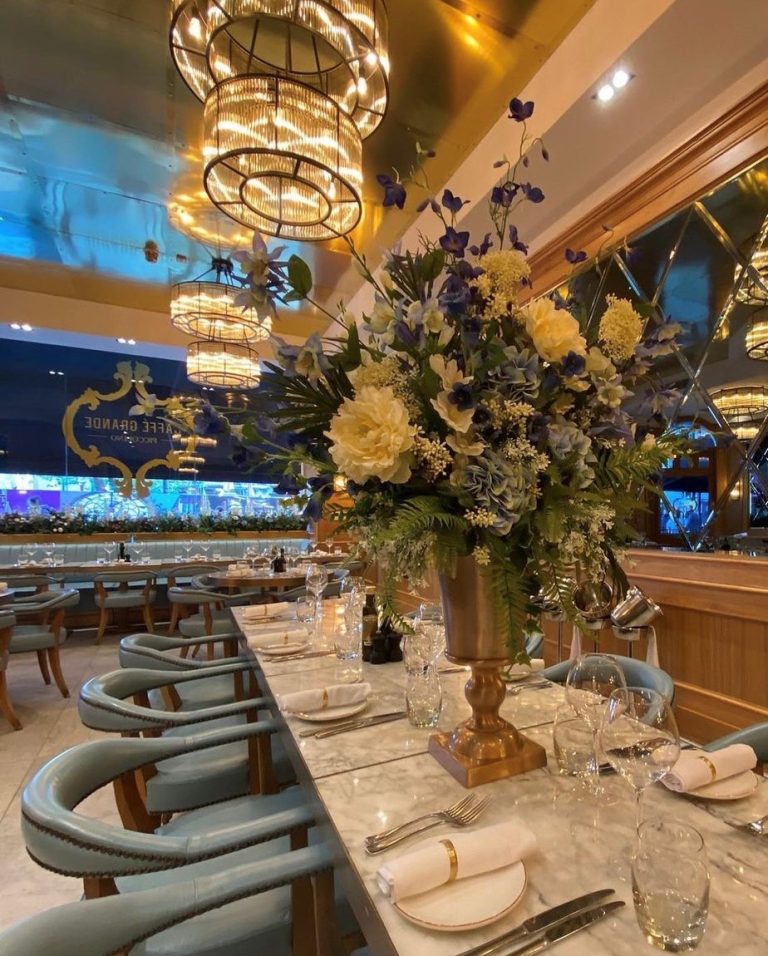 Photograph of seating with flower centrepiece in the private dining area at Piccolino Caffe Grande.